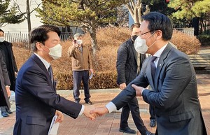 안철수 후보(왼쪽)가 홍주의 회장과 악수를 나누고 있다.